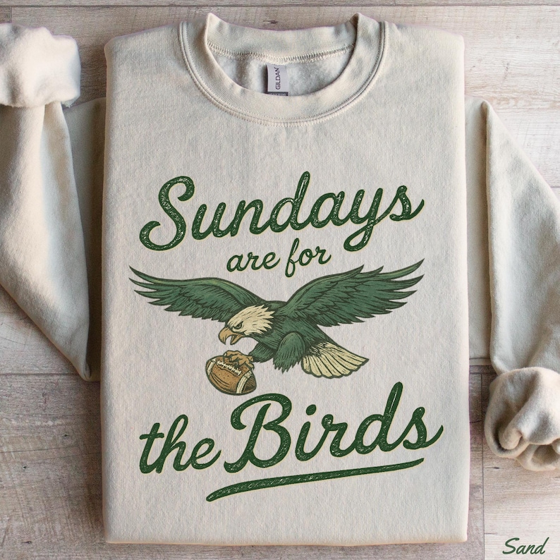 A white sweatshirt with a graphic design and text printed on it.