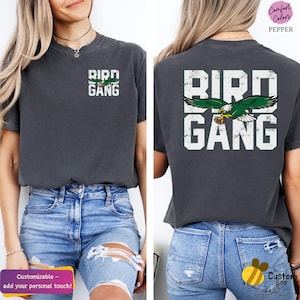 a woman wearing a bird gang t - shirt