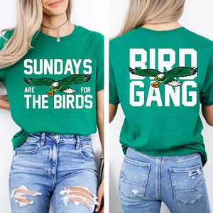 a woman wearing a green shirt with the words bird gang on it
