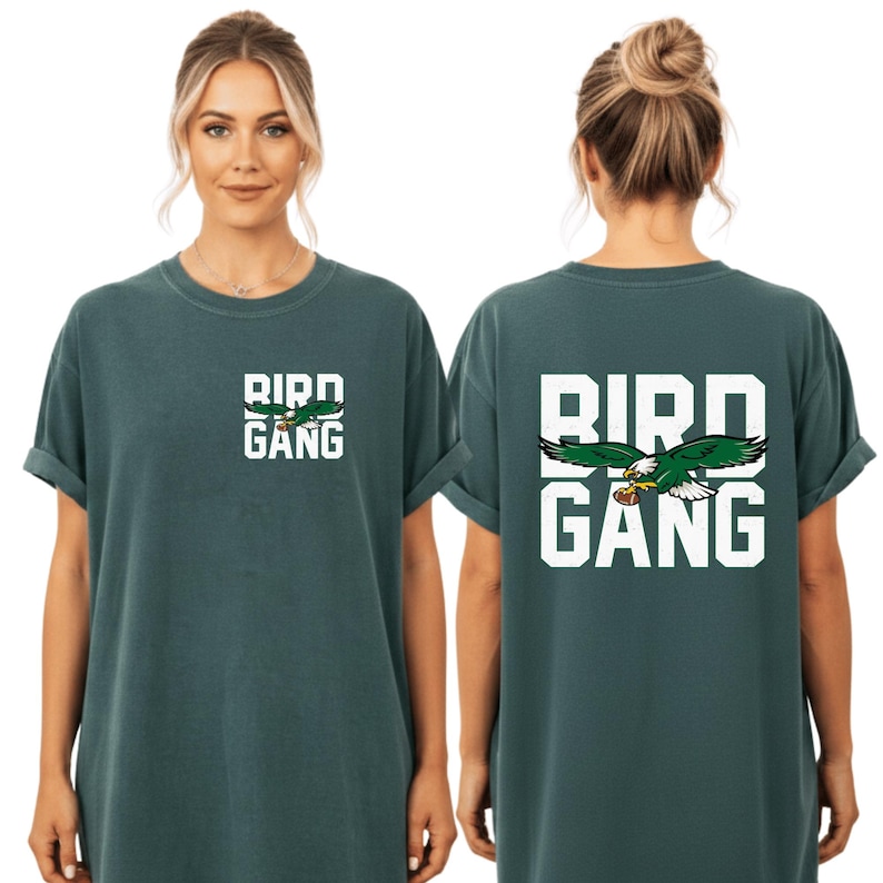 A woman wearing a green t-shirt with the text "BIRD GANG" printed on it.