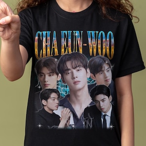 May include: Black t-shirt with the text "CHA EUN-WOO" in a retro style, and a collage of images of a group of young men. The shirt is worn by a person.