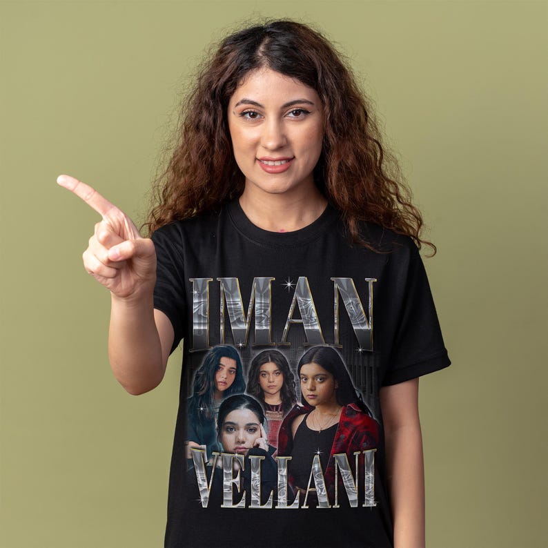 May include: A black short-sleeved t-shirt featuring a graphic print of Iman Vellani. The design includes the name IMAN VELLANI in large metallic silver lettering above and below a collage of four photographic portraits of the actor.