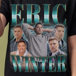 May include: Black t-shirt featuring a graphic design with the name "ERIC WINTER" in teal lettering. The design includes multiple images of a man in various poses, with a teal lightning bolt background.
