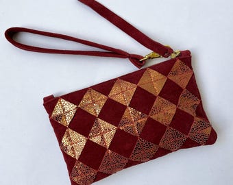 Metallic gold and red leather diamond zip pouch. Repurposed gold leather diamond chips on brick red suede, brass zipper, fully lined.