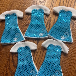 May include: Five blue and white sequined dresses with snowflake embroidery. The dresses are made of felt and have a white trim.
