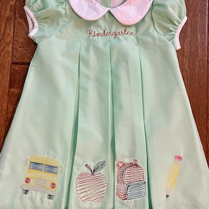 School embroidered pleat dress