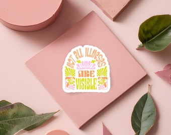 Pode incluir: Um adesivo com um design floral rosa, laranja e verde. O adesivo diz "Not all illnesses are visible".