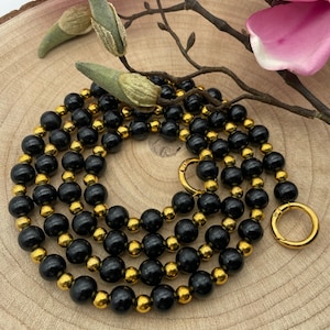 Chaîne de téléphone portable noire/dorée, collier de perles, perles en bois, élégante, robuste, stable avec mousqueton et insert pour étui/patch de téléphone portable.