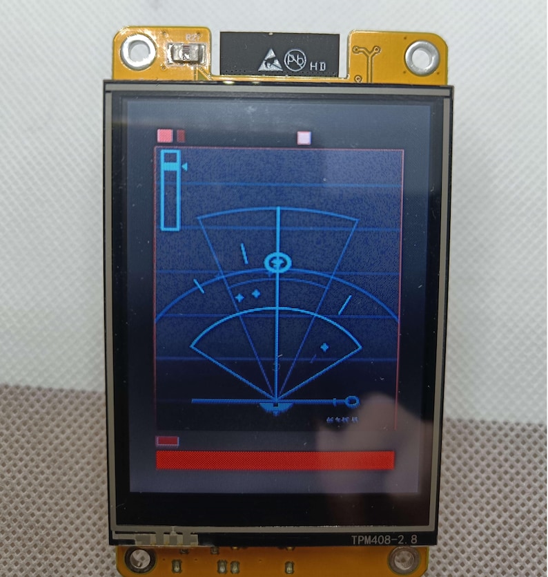 May include: A blue and white radar screen with a red bar at the bottom. The screen is on a yellow circuit board with the text "TPM408-2.8" printed on it.