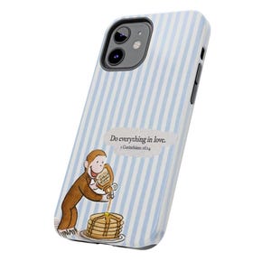 May include: A phone case with a light blue and white striped pattern. The case features a cartoon illustration of a monkey pouring syrup on pancakes. Text on the case reads "Do everything in love. 1 Corinthians 16:14."