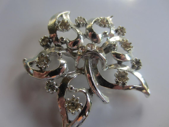 Broche bouquet de fleurs antique Art déco en métal argenté avec strass transparents. - France