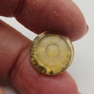 May include: A white ceramic mug with a black handle and the text "But First, Coffee" in a black, bold font. The mug is on a white surface.