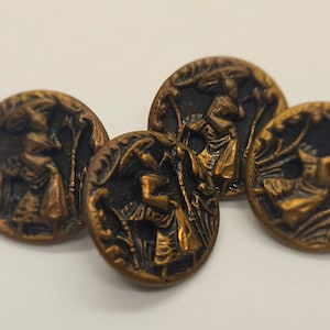 May include: Four antique copper-coloured buttons with a detailed relief design. Each button features a central figure in a landscape setting, surrounded by foliage. The buttons are round and have a dark patina.