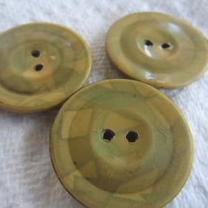 May include: Three green and brown patterned buttons with two holes each.