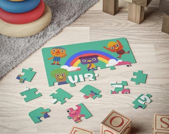 May include: A green and colorful puzzle with a rainbow and cartoon characters. The puzzle is partially assembled with some pieces missing. The puzzle is on a wooden surface with wooden blocks that spell out "TOYS".