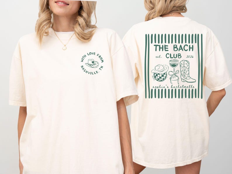 May include: Cream-colored t-shirt with green text and graphics. The front features a circular design with a cowboy hat and the text "With Love From Nashville TN." The back displays "THE BACH CLUB est. 2026" with related illustrations.