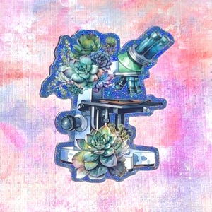 May include: A die-cut sticker featuring a scientific microscope adorned with various green and purple succulent plants. The microscope has a metallic frame and blue-tinted lenses, with clusters of detailed succulents arranged around the base.