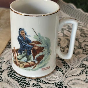 Norman Rockwell “Braving the Storm” Collector Mug – 1985 – Made in Japan – Gold Trim – 4.5” Tall