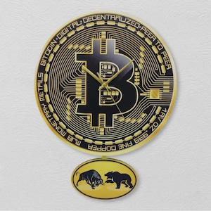 May include: A Bitcoin-themed wall clock with a gold and black design. The clock face is shaped like a Bitcoin coin, with the Bitcoin symbol in the center. The clock has gold hands and a pendulum with a bull and bear graphic.