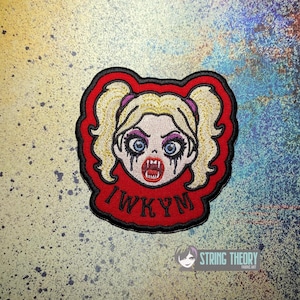 May include: An embroidered patch featuring a cartoon character with blonde pigtails, blue eyes, and dark makeup running down the cheeks. The character has sharp fangs and an open mouth. The red background includes the black text IWKYM.