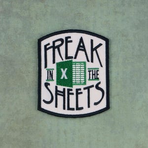 May include: White embroidered patch with black outline. The patch says "Freak in x the Sheets" with a green spreadsheet icon.