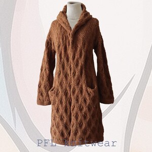 May include: A brown knitted cardigan with a hood and pockets. The cardigan features a diamond pattern and is made from a soft, cosy material.