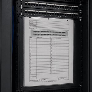 May include: A black server rack cabinet containing a network patch panel with numerous ports and a white documentation sheet attached to the front. The sheet features a printed table with columns for port numbers and descriptions for network organisation.