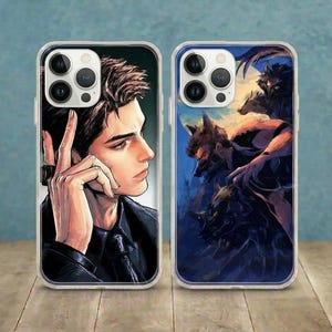 May include: Two smartphone cases featuring anime-style illustrations. The left case depicts a person with dark hair in a black suit, while the right case shows a dark, shadowy figure surrounded by multiple wolf-like creatures against a yellow moon.