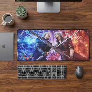 May include: A rectangular mouse mat with a colourful illustration of two characters from the video game Devil May Cry, with a sword in the center. The Devil May Cry logo is at the bottom. A keyboard, mouse, and monitor are also visible.