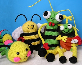 May include: Four crocheted stuffed animals: a yellow and black bee, a green and black praying mantis, a yellow and orange ladybug, and a multi-colored caterpillar.