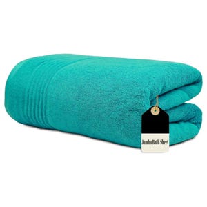 May include: A folded, teal jumbo bath sheet. The plush towel is folded neatly, with ribbed detailing on one end. A black and white tag reads "Jumbo Bath Sheet".