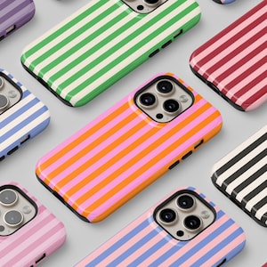May include: A collection of striped phone cases in various colors, including purple, green, pink, blue, red, black, and white. The cases are all designed with a simple, modern aesthetic.