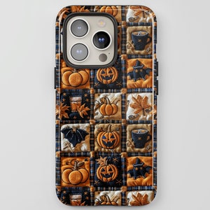 May include: A black phone case with a patchwork design featuring pumpkins, bats, and autumn leaves. The case has a camera cutout and a raised lip around the edges.