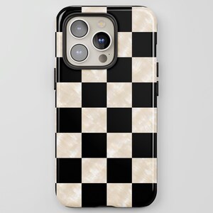 May include: A smartphone case featuring a repeating checkerboard pattern of solid black squares and off-white squares with a subtle, marbled texture. The case includes a cutout for a triple-lens camera system on the upper left side of the back.