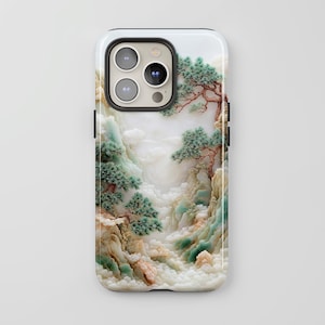 May include: A white phone case with a carved jade design featuring a mountain landscape with trees. The phone case has a black camera cutout.