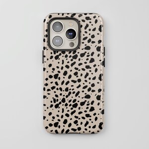 May include: A beige phone case with a black dalmatian print pattern.
