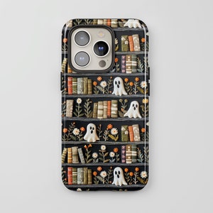 May include: A black phone case with a spooky design featuring a bookshelf filled with books, ghosts, and flowers. The case has a camera cutout and a white background.