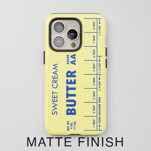 May include: A yellow phone case with a design that looks like a stick of butter. The design includes the text "Sweet Cream" and "Butter AA" with a measurement guide in tablespoons and cups.