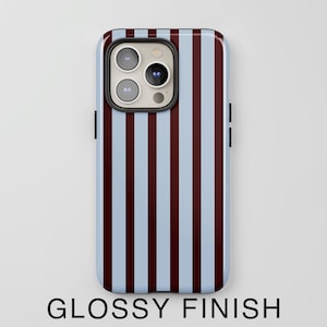 May include: A smartphone case with a glossy finish. The case features a pattern of vertical stripes in light blue and maroon. The phone's camera and buttons are visible. The text "GLOSSY FINISH" is at the bottom.