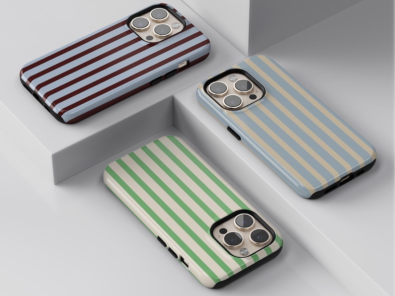 May include: Three smartphone cases with striped patterns. One case has blue and brown stripes, another has blue and beige stripes, and the third has green and white stripes. The cases have a glossy finish and a black border.