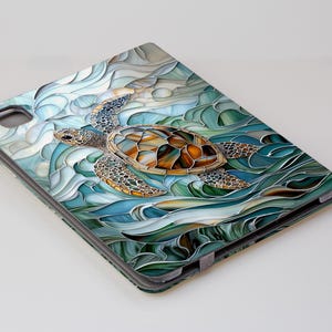 May include: A stained glass style illustration of a sea turtle swimming in blue and green waves. The turtle is brown and gold with a detailed shell.