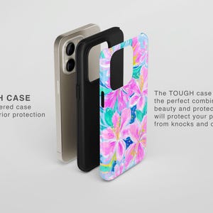 May include: A phone case with a floral design in pink, blue, and green. The case is shown in layers, with a black inner case and a phone visible behind it. Text on the left reads "TOUGH CASE" and "Dual layered case for superior protection."