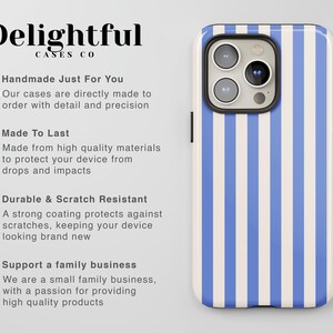 May include: A blue and white striped phone case with a camera lens cutout. The case is made by Delightful Cases Co. and is handmade with detail and precision. The text on the case says "Handmade Just For You", "Made To Last", "Durable & Scratch Resistant", and "Support a family business".