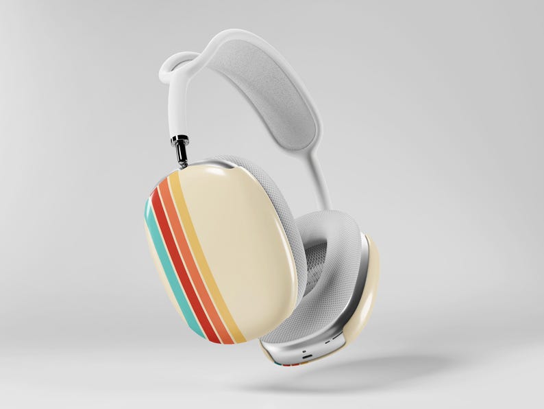 May include: White over-ear headphones with a cream-colored ear cup featuring a retro stripe design in teal, orange, red, and yellow. The headband and ear cushions are white. The headphones have a silver metal trim.