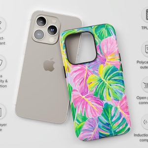 May include: A silver iPhone next to a colorful phone case. The case features a tropical leaf design in pink, green, and yellow. The case has a dual-layer design for extra durability and protection. It is impact-resistant and compatible with induction chargers.