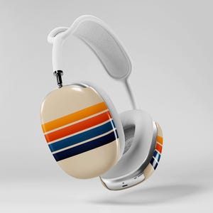 May include: White over-ear headphones with a cream-colored ear cup featuring horizontal stripes in orange, red, and blue. The headphones have a white headband and ear cushions. The design is retro-inspired.