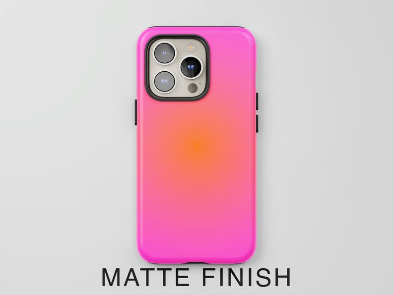 May include: A matte finish phone case with a vibrant pink and orange gradient. The case has a black border around the camera and sides. The text "MATTE FINISH" is displayed at the bottom.