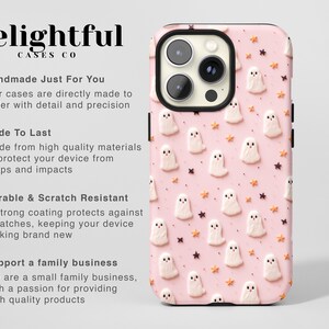 May include: A pink phone case featuring a pattern of white ghosts and gold stars. The case is designed for a phone with a triple lens camera.