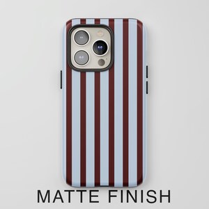 May include: A smartphone case with a matte finish. The case features a vertical striped pattern in light blue and burgundy. The text "MATTE FINISH" is printed at the bottom of the case.