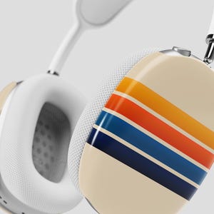 May include: White wireless headphones with a retro-style striped design in orange, yellow, blue, and navy blue.